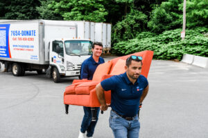 2 men carry a couch